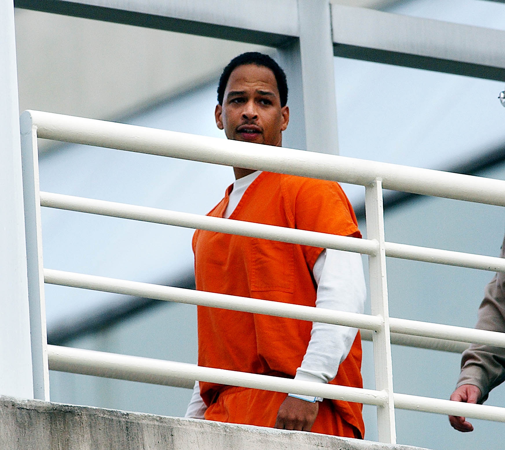 PHOTO: Former Carolina Panther Rae Carruth is escorted by Mecklenburg County Sherrif deputies into the Mecklenburg County Courthouse for a civil hearing, Oct. 13, 2003, in Charlotte, N.C.