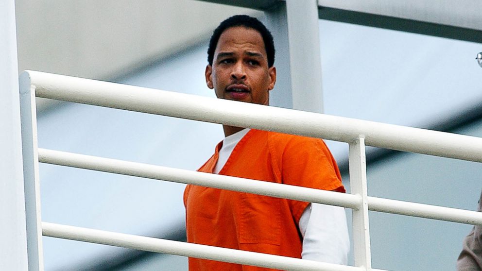 PHOTO: Former Carolina Panther Rae Carruth is escorted by Mecklenburg County Sherrif deputies into the Mecklenburg County Courthouse for a civil hearing, Oct. 13, 2003, in Charlotte, N.C.