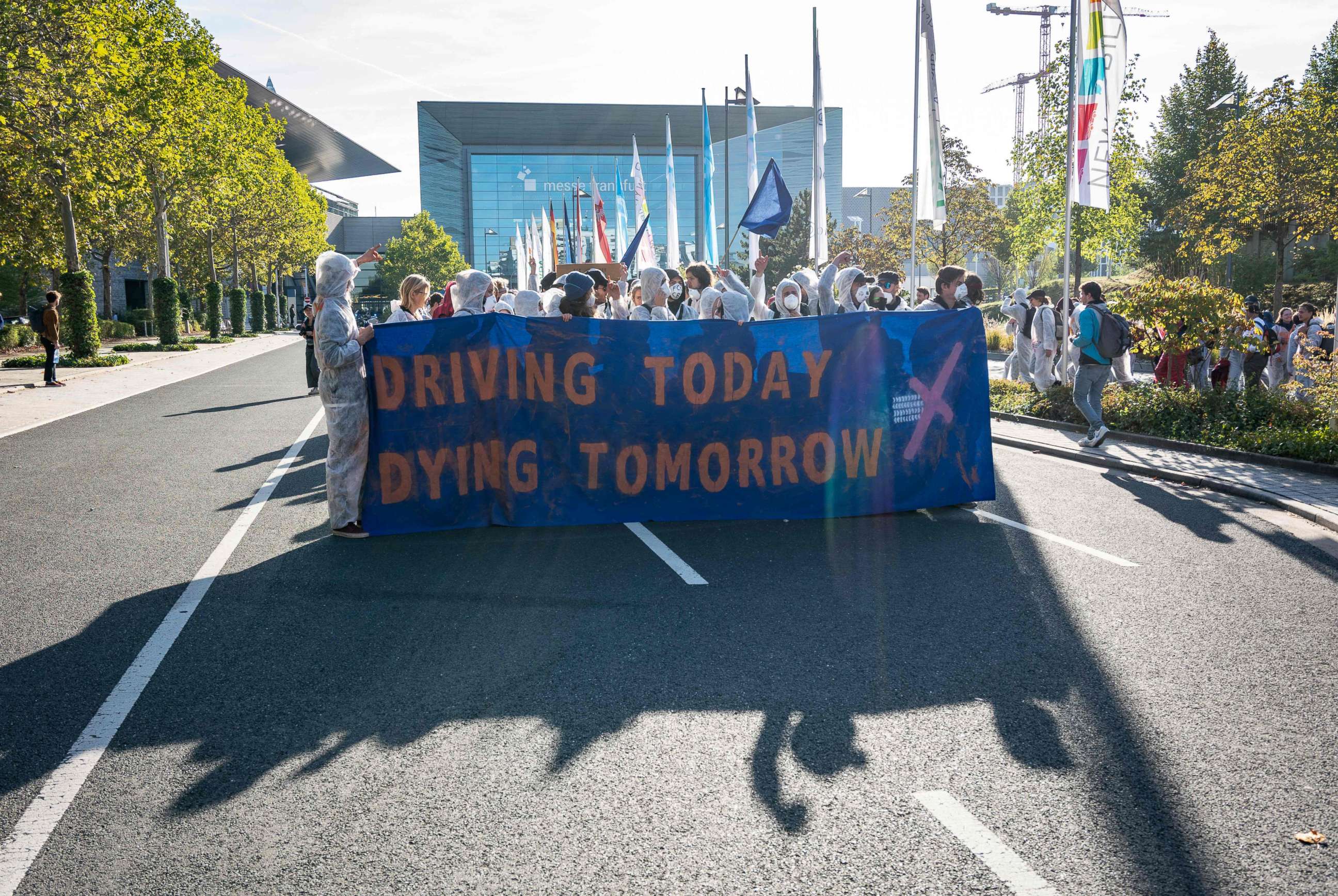 PHOTO: Demonstrators from the action group "Sand im Getriebe" (grit in the gears) are calling for a change in transport policy and in the motor industry, Sept. 15, 2019, outside the fairgrounds in Frankfurt am Main, western Germany.