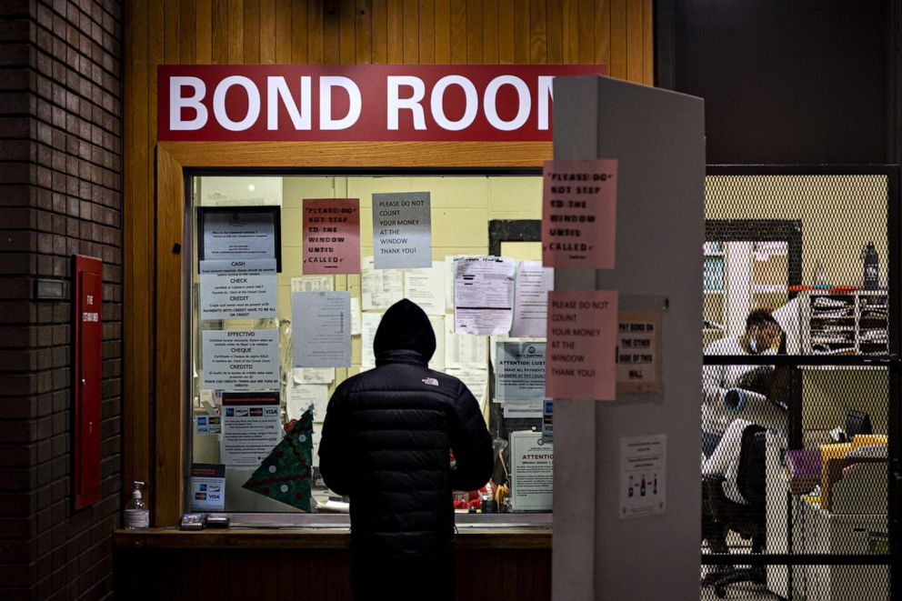 PHOTO: A man pays cash bail in the bond office to secure his brother's release on Dec. 21, 2022 at Division 5 of Cook County Jail in Chicago. The elimination of cash bail is among the criminal justice reforms in the SAFE-T Act.