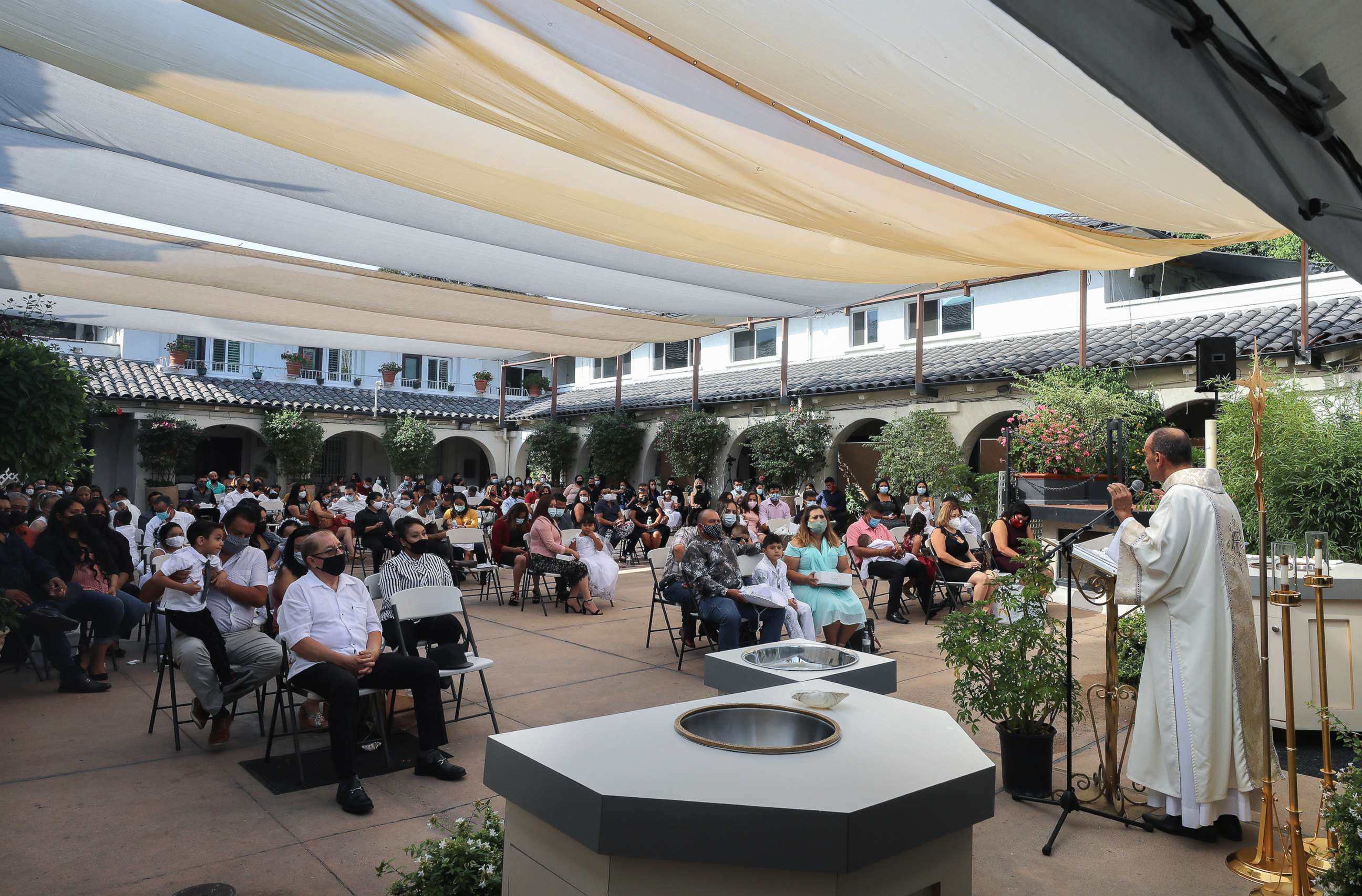 PHOTO: In this Sept. 26, 2020, The Rev. Arturo Corral speaks during baptism ceremonies at the historic Our Lady Queen of Angels Church amid the COVID-19 pandemic in Los Angeles.