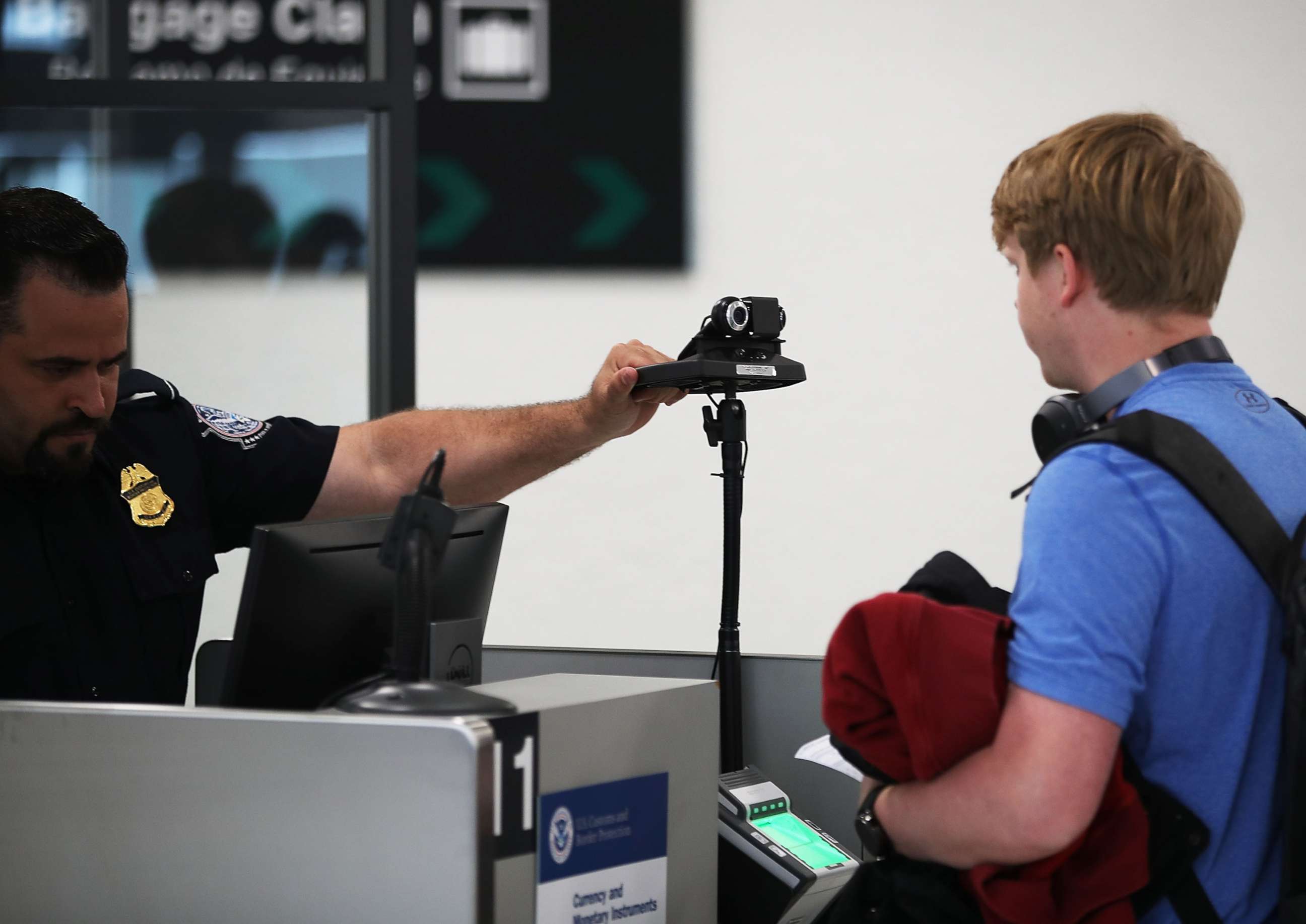 PHOTO: A U.S. Customs and Border Protection officer instructs an international traveler to look into a camera as he uses facial recognition technology to screen a traveler entering the U.S. on Feb. 27, 2018 at Miami International Airport in Miami, Fla.