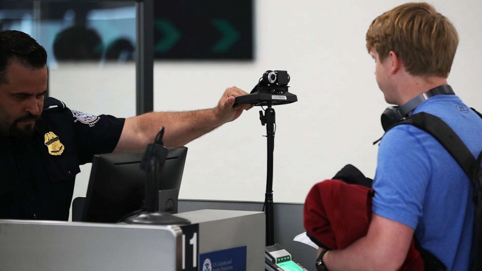 PHOTO: A U.S. Customs and Border Protection officer instructs an international traveler to look into a camera as he uses facial recognition technology to screen a traveler entering the U.S. on Feb. 27, 2018 at Miami International Airport in Miami, Fla.