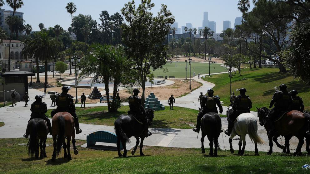 PHOTO: Federal agents ride on horseback at MacArthur Park, July 7, 2025, in Los Angeles. 