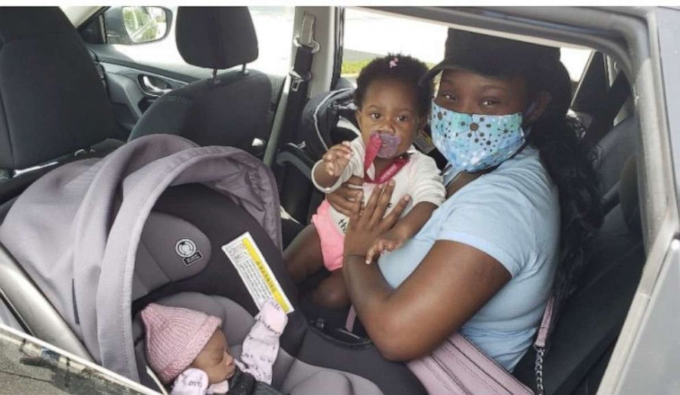 PHOTO: Crysten Dve Graham holds her daughter Tai  and rides with her newborn Cea after they left the hospital on April 22, 2020, in Lilburn, Ga.