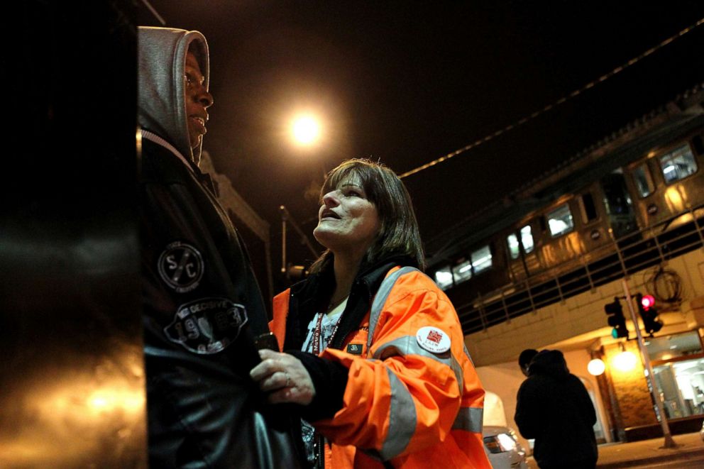 PHOTO: An outreach worker for Ceasefire in Chicago's Rogers Park neighborhood, talks with a teenager, March 1, 2012.