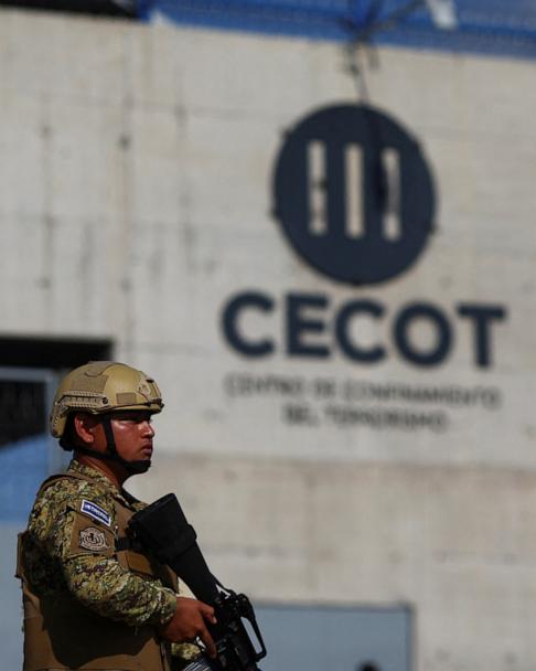 A Salvadoran soldier stands guard, as the CECOT logo is seen at the Terrorism Confinement Center prison, in Tecoluca, El Salvador April 4, 2025. 