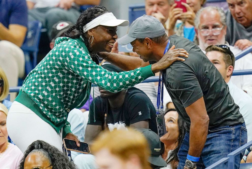 PHOTO: Tiger Woods greets Venus Williams while watching play between Serena Williams, of the United States, and Anett Kontaveit, of Estonia, during the second round of the U.S. Open tennis championships in New York, Aug. 31, 2022.