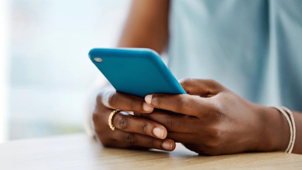 PHOTO: Black woman using cell phone