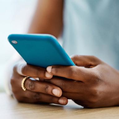 PHOTO: Black woman using cell phone