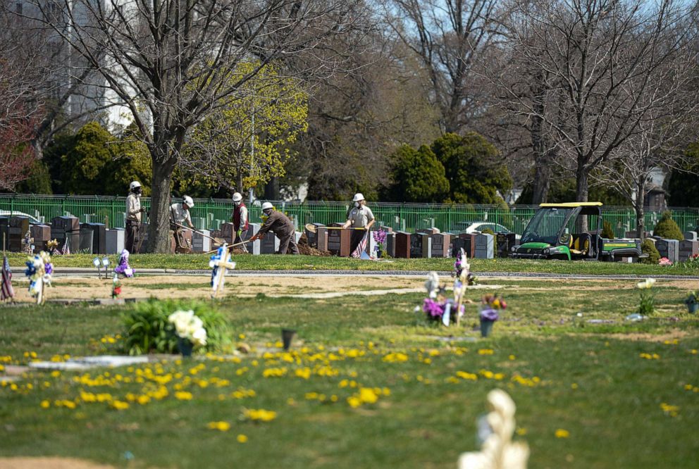 PHOTO: Cemetery workers prepare graves at a cemetery in Queens, New York, April 7, 2020.