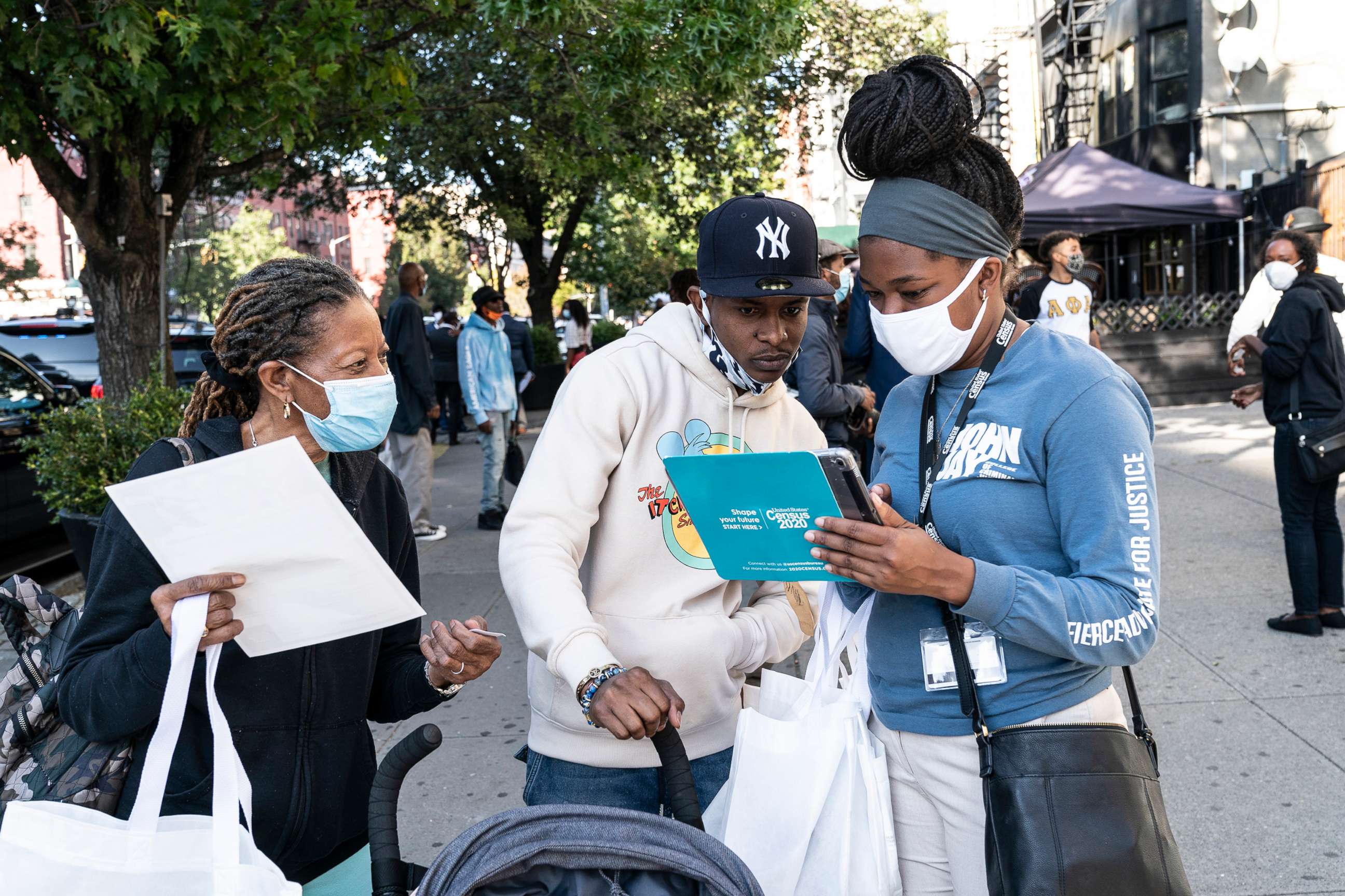 PHOTO: Census 2020 employees help New Yorkerers fill out the census form at Sylvia's Restaurant in Harlem during Census Drive, Sept. 9, 2020.