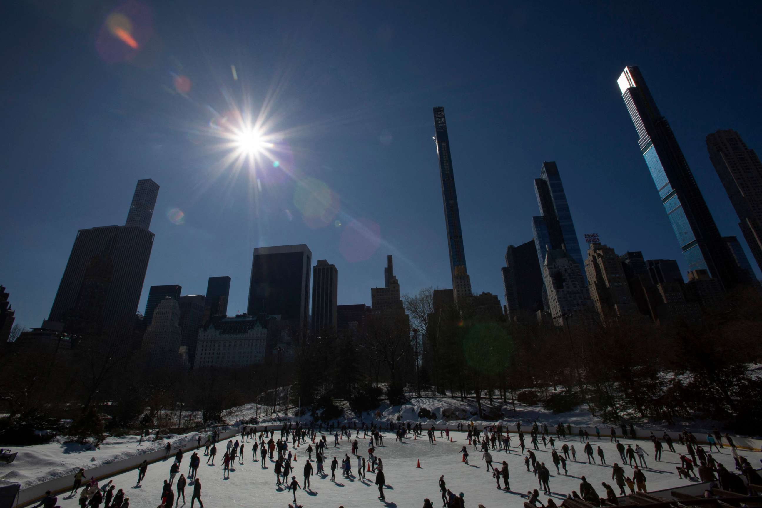 PHOTO: TOPSHOT - People visit the Wollman ice skating rink before it closes at the end of the day in Central Park in New York City on Feb. 21, 2021. 