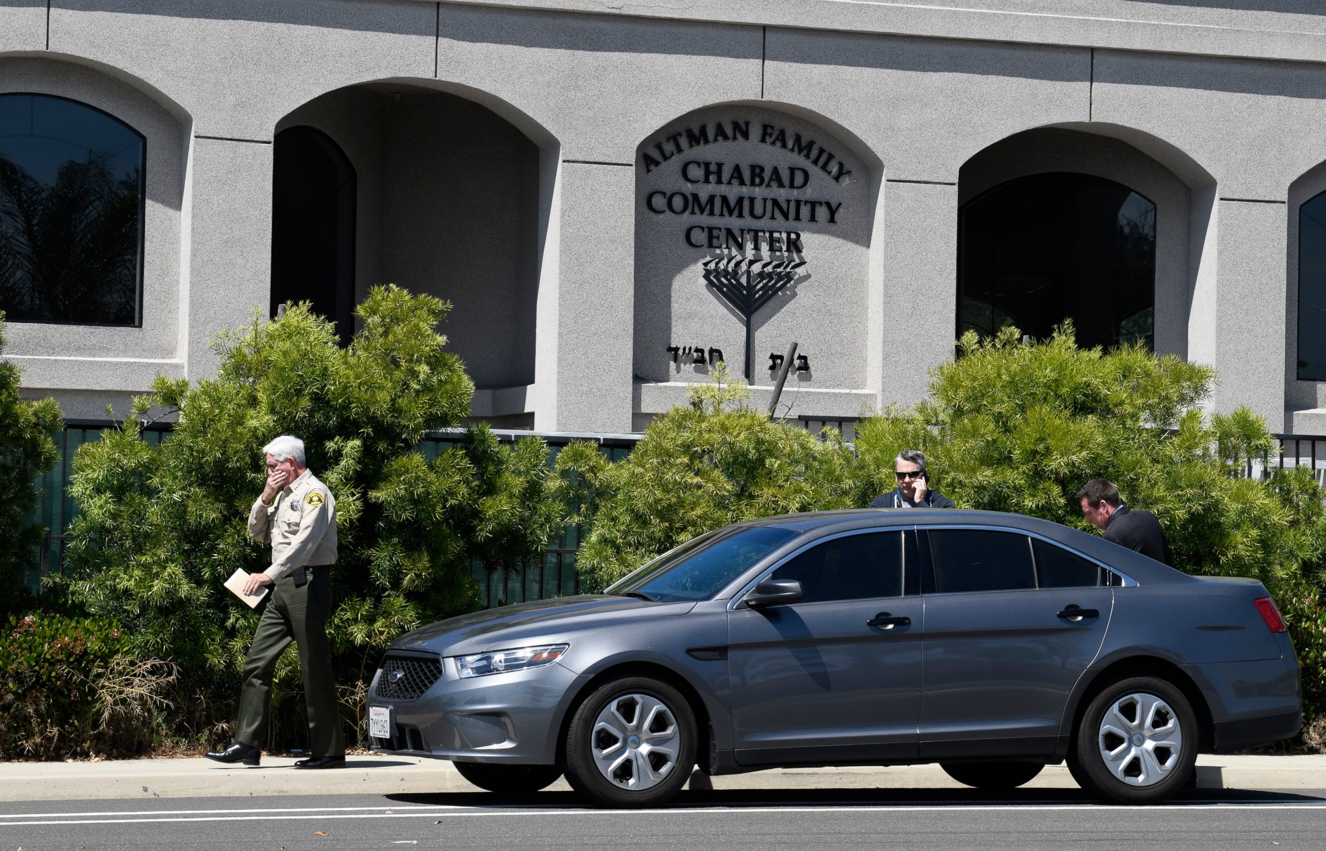 PHOTO: San Diego County Sheriff Bill Gore, left, walks past the Chabad of Poway Synagogue Saturday, April 27, 2019, in Poway, Calif. Several people were injured in a shooting at the synagogue. 