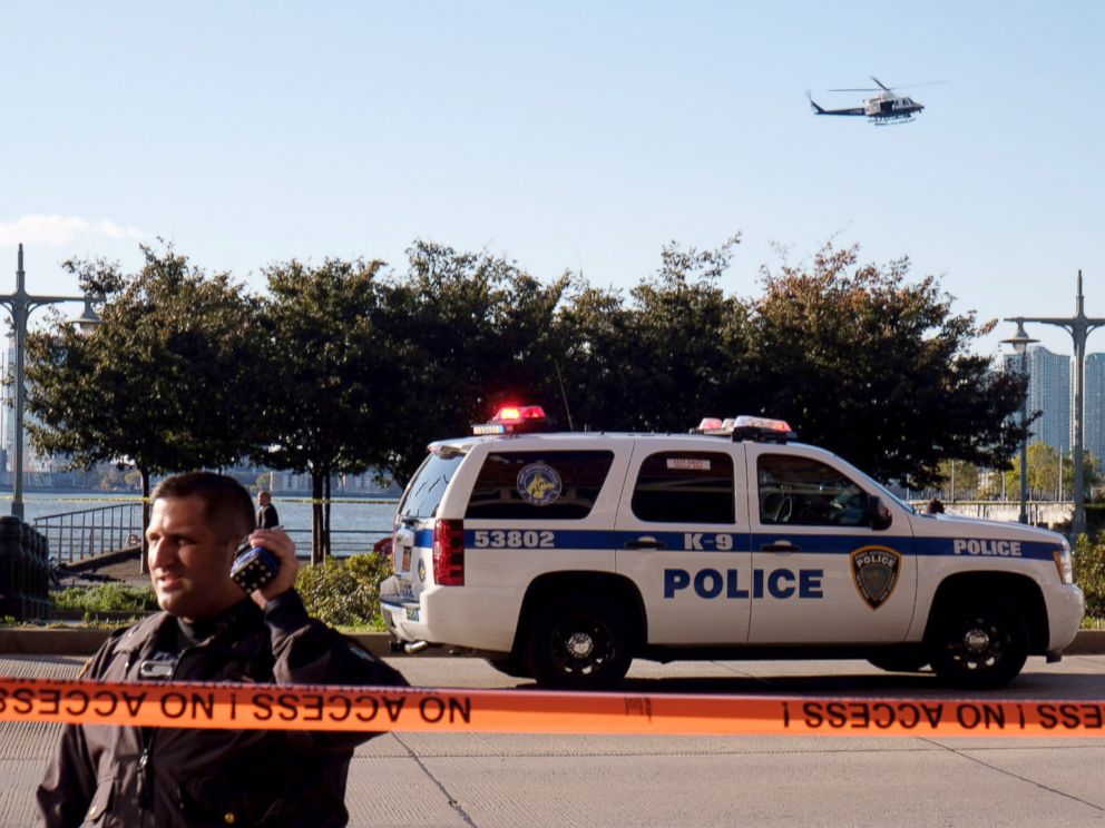 PHOTO: Police gather at the scene after reports of multiple people injured after a truck plowed through a bike path in lower Manhattan, Oct. 31, 2017, in New York City.