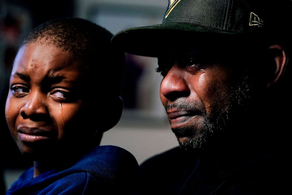 PHOTO: Wayne Jones, holds his son Donell, while speaking about his mother Celestine Chaney, who was killed in Saturday's shooting at a supermarket, in Buffalo, N.Y., May 16, 2022.