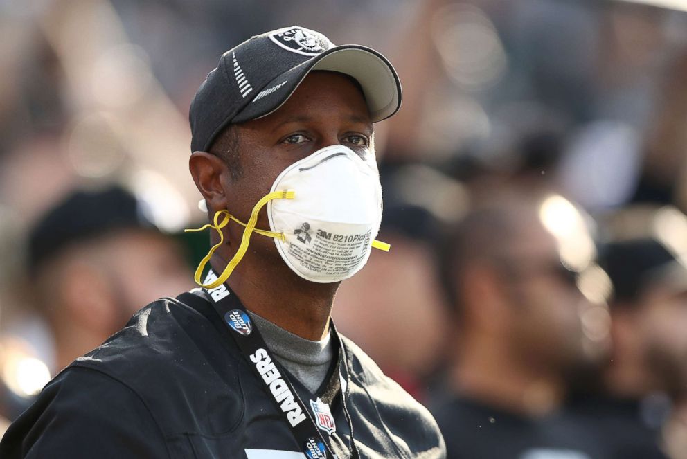 PHOTO: A fan wears a face mask in the stands during the NFL game between the Oakland Raiders and the Los Angeles Chargers at Oakland-Alameda County Coliseum, Nov. 11, 2018 in Oakland, Calif.