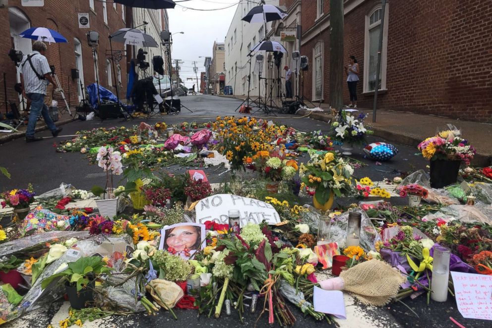 PHOTO: lowers are left in the street creating a make-shift memorial for Heather Heyer, who was killed during the 2017 protests in Charlottesville, Va.