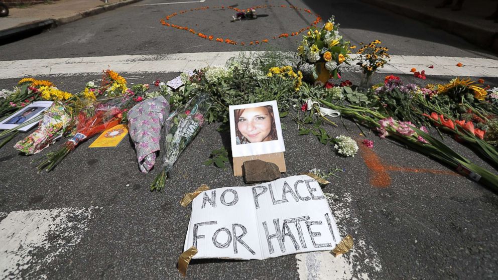 Flowers surround a photo of 32-year-old Heather Heyer, who was killed when a car plowed into a crowd of people protesting against the white supremacist Unite the Right rally, Aug. 13, 2017 in Charlottesville, Va.