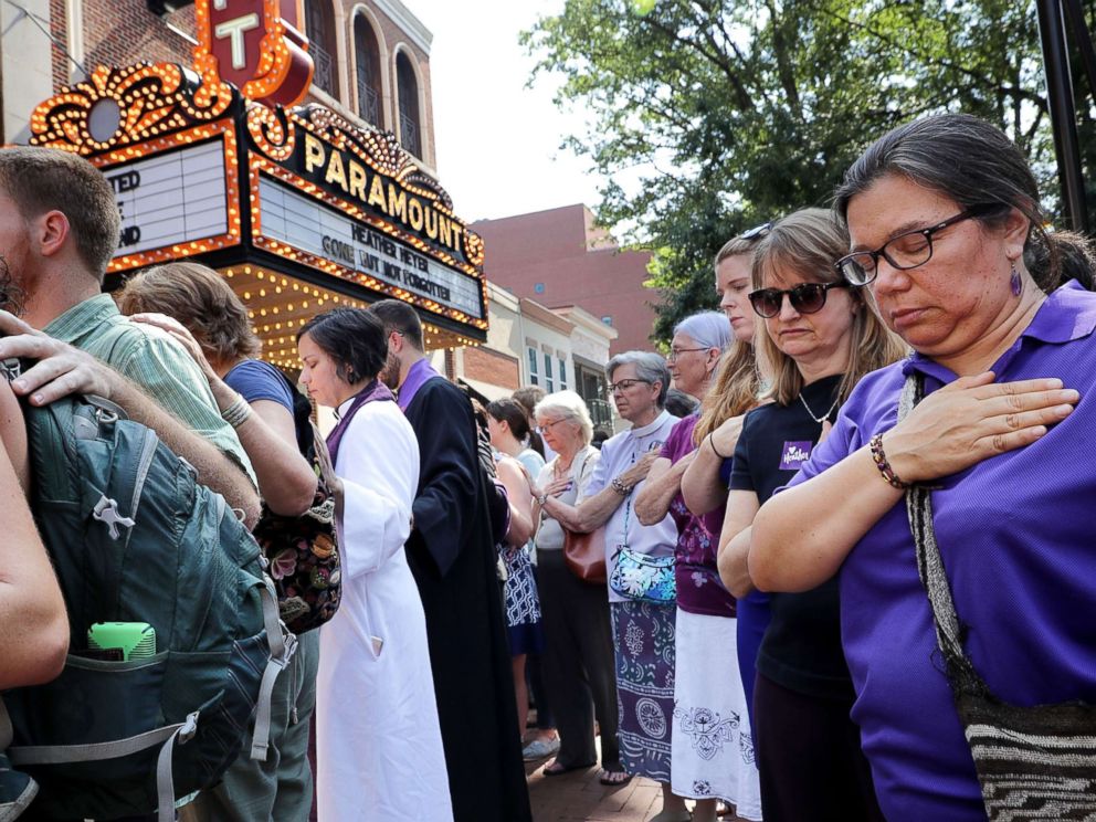 PHOTO: People observe a moment of silence during the memorial service for Heather Heyer outside the Paramount Theater, Aug. 16, 2017, in Charlottesville, Va.
