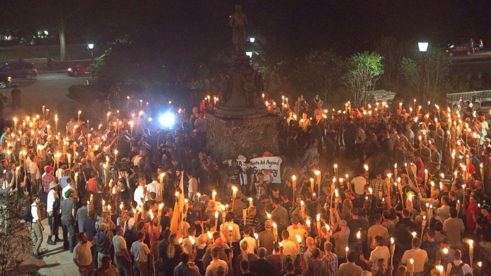 PHOTO: White nationalists carry torches around a statue of Thomas Jefferson on the grounds of the University of Virginia, on the eve of a planned Unite The Right rally in Charlottesville, Va., Aug. 11, 2017. 