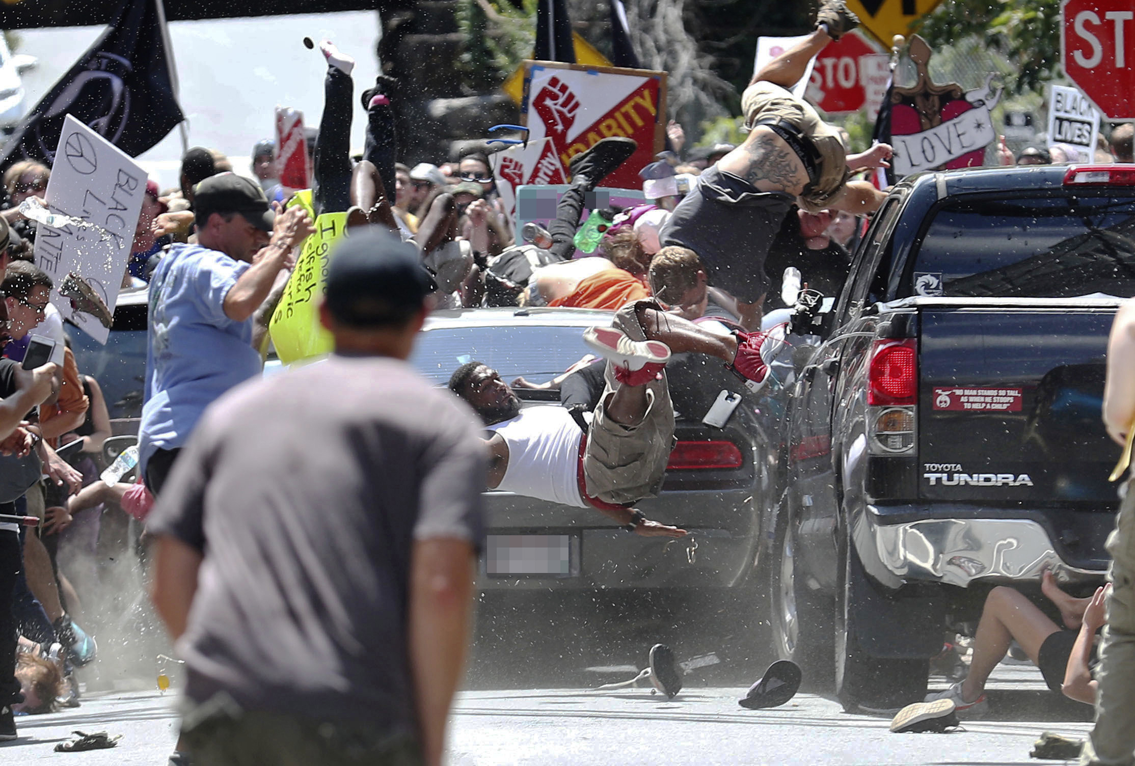 PHOTO: People fly into the air as a vehicle drives into a group of protesters demonstrating against a white nationalist rally in Charlottesville, Va., Aug. 12, 2017.