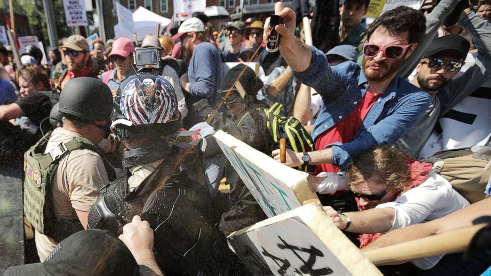 PHOTO: White nationalists exchange volleys of pepper spray with counterprotesters as they enter Lee Park during the Unite the Right rally on Aug. 12, 2017, in Charlottesville, Va. 