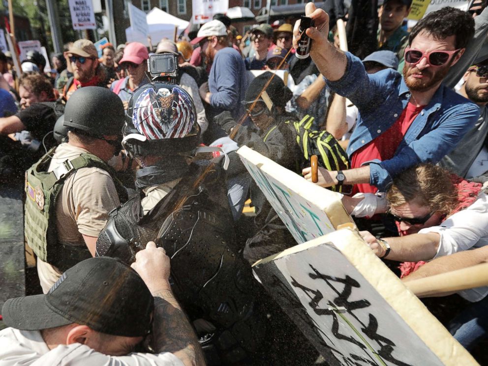 PHOTO: White nationalists exchange volleys of pepper spray with counterprotesters as they enter Lee Park during the Unite the Right rally on Aug. 12, 2017, in Charlottesville, Va.