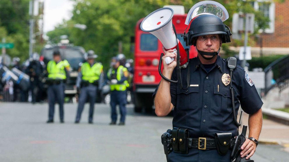 PHOTO: A police officer stands in the middle of the street after declaring the protest an unlawful assembly during a white nationalist rally, Aug. 12, 2017, in Charlottesville, Va.