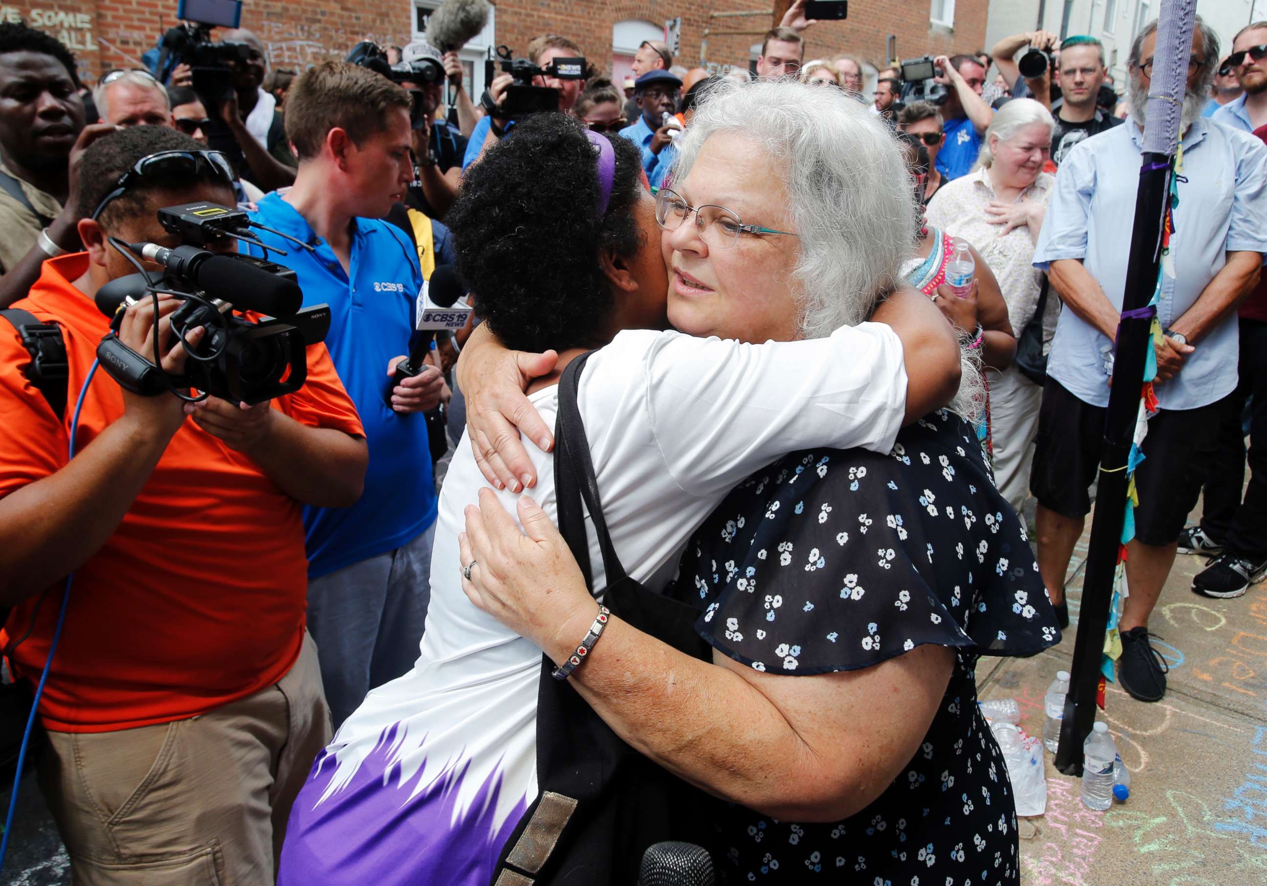 PHOTO: Susan Bro, the mother of Heather Heyer who was killed during last year's "Unite the Right" rally, embraces supporters after laying flowers at the spot her daughter was killed in Charlottesville, Va., Aug. 12, 2018.