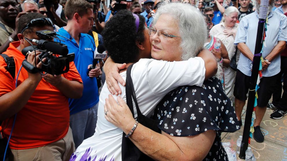 PHOTO: Susan Bro, the mother of Heather Heyer who was killed during last year's "Unite the Right" rally, embraces supporters after laying flowers at the spot her daughter was killed in Charlottesville, Va., Aug. 12, 2018.