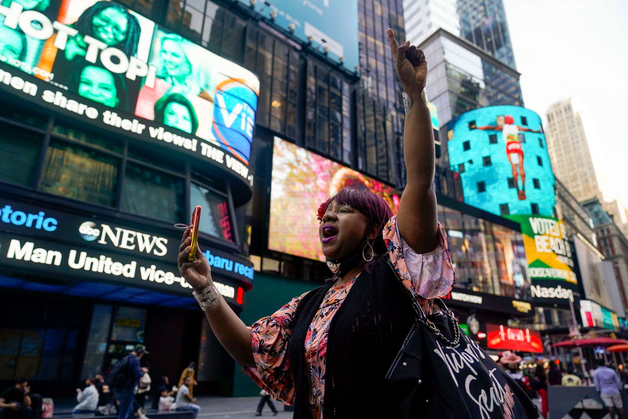 PHOTO: AniYa A motions as she walks through Times Square in New York, while talking on her cell phone after a Minnesota jury found Former Minneapolis police officer Derek Chauvin guilty of murder and manslaughter, April 20, 2021. 
