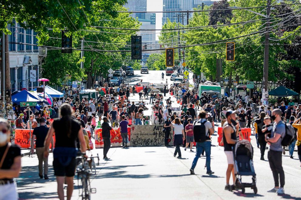 PHOTO: People walk around the newly created Capitol Hill Autonomous Zone (CHAZ), in Seattle,  June 11, 2020.