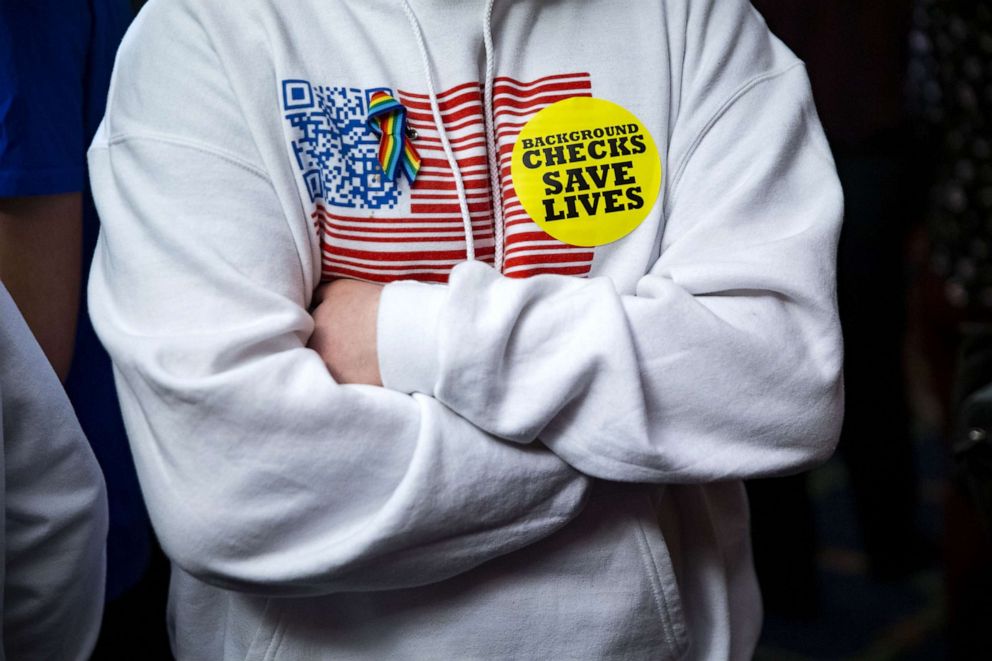 PHOTO: An attendee wears a "Background Checks Saves Lives" sticker during the unveiling of legislation to expand background checks for sales of firearms in Washington, D.C., Jan. 8, 2019. 