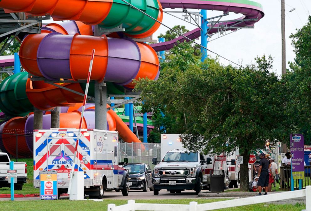 PHOTO: Emergency personnel vehicles are parked near the scene where people are being treated after chemical leak at Six Flags Hurricane Harbor Splashtown, July 17, 2021 in Spring, Texas.