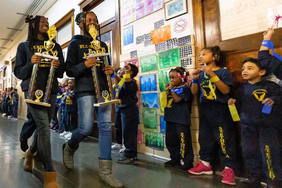 PHOTO: Trechelle Williams and Shakira Luster walk the hall during their school's pep rally.