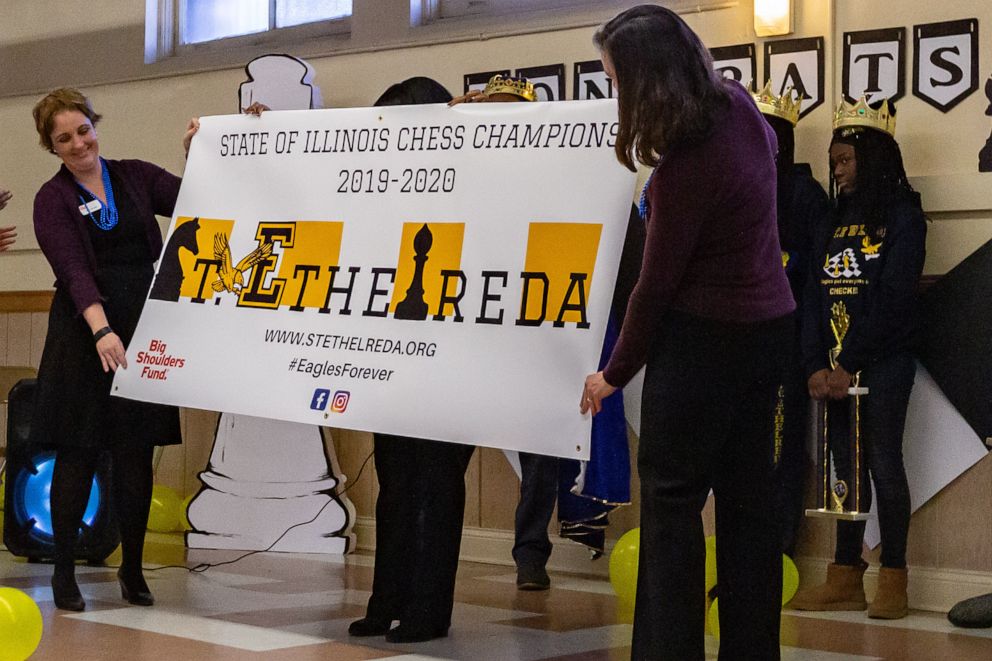 PHOTO: St. Ethelreda School is presented with a banner as state champions in chess during their pep rally.