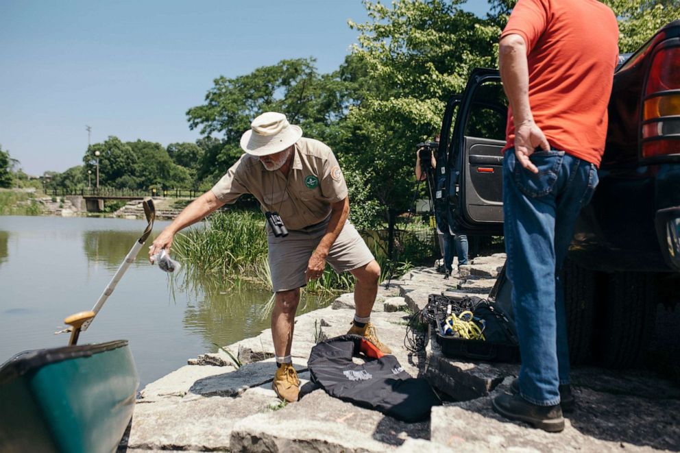 PHOTO: A volunteer with the Chicago Herpetological Society who goes by "Alligator Bob" sets out in his canoe to find and document an alligator spotted in Chicago's Humboldt Park lagoon, July 9, 2019.