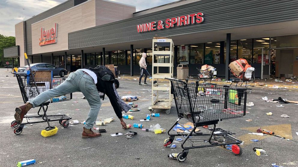 PHOTO: People clean up items outside a Jewel grocery store, June 1, 2020, in the Bronzeville neighborhood of Chicago, after the business was broken into during unrest in reaction to the death of George Floyd.