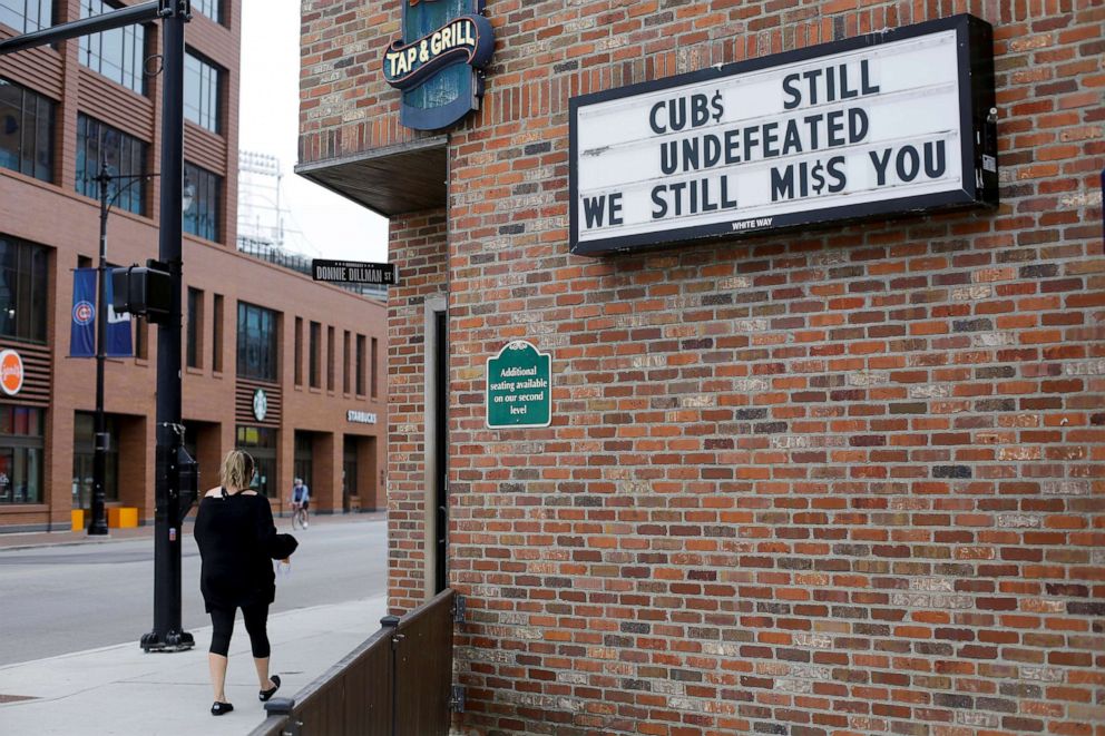 PHOTO: A sign is displayed on a business across the street from the Chicago Cubs home stadium of Wrigley Field, which has been closed due to the coronavirus disease (COVID-19) restrictions in Chicago, May 20, 2020.
