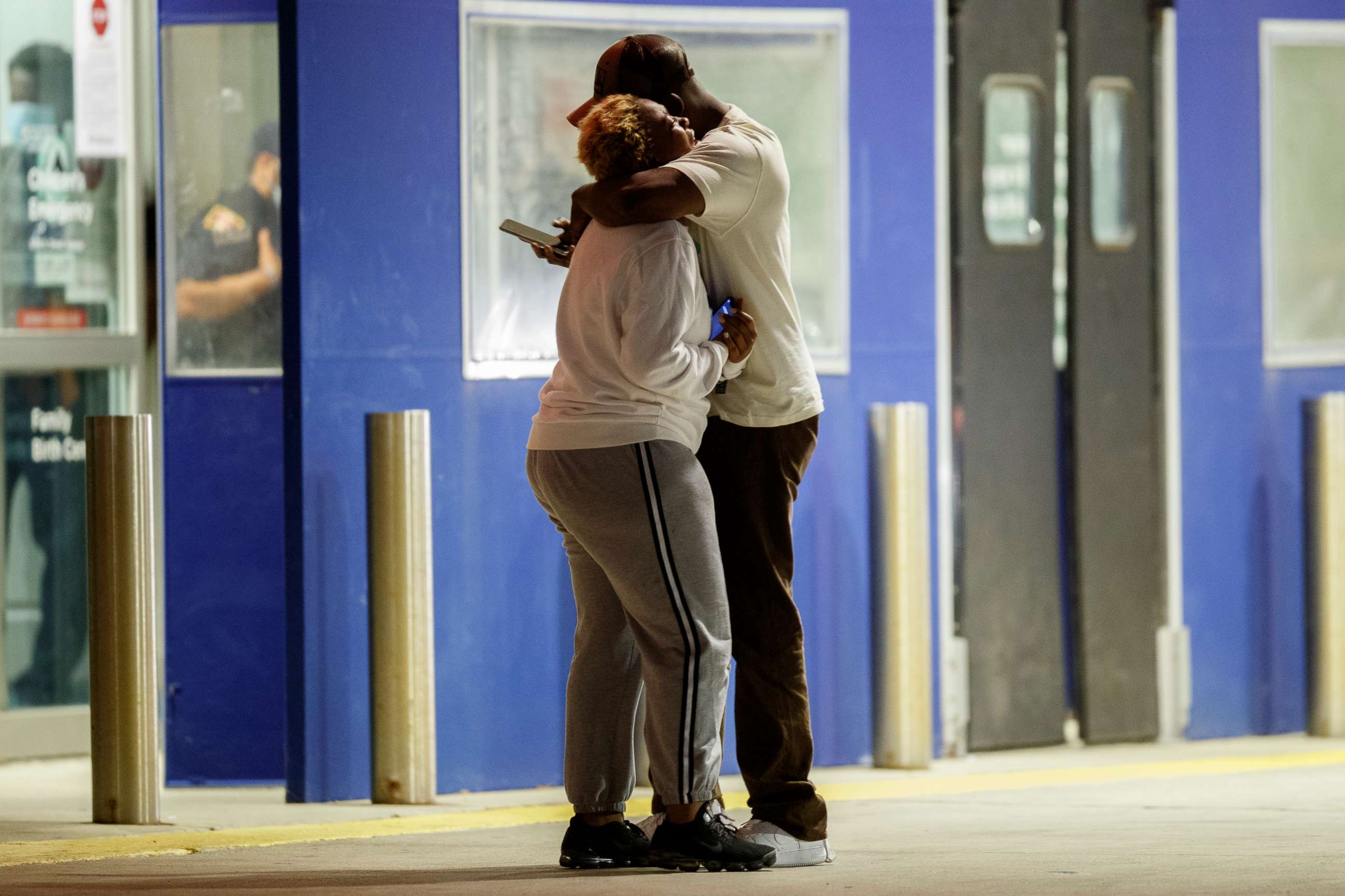 PHOTO: Two people hug one another outside the University of Chicago Medicine's Comer Children's Hospital where a 8-year-old girl was taken after being killed in a shooting in Chicago, Sep. 7, 2020.