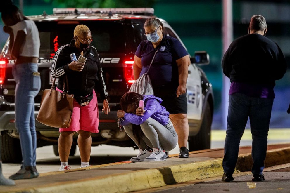 PHOTO: A woman kneels on the ground outside the University of Chicago Medicine's Comer Children's Hospital where a 8-year-old girl was taken after being killed in a shooting that wounded three others in Chicago, Sep. 7, 2020.