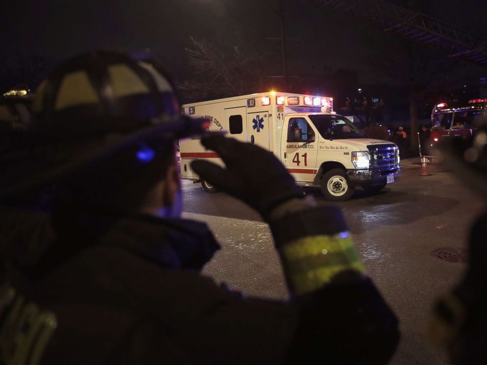 PHOTO: Firefighters and police officers salute as the ambulance carrying the remains of Chicago Police officer Samuel Jimenez arrive at the Cook County Medical Examiners office, Nov. 19, 2018, in Chicago.