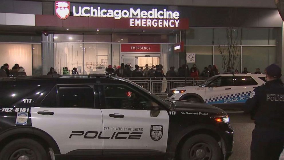 PHOTO: People wait outside a hospital in Chicago where a 29-year-old woman was taken after being shot, Jan. 12, 2022.