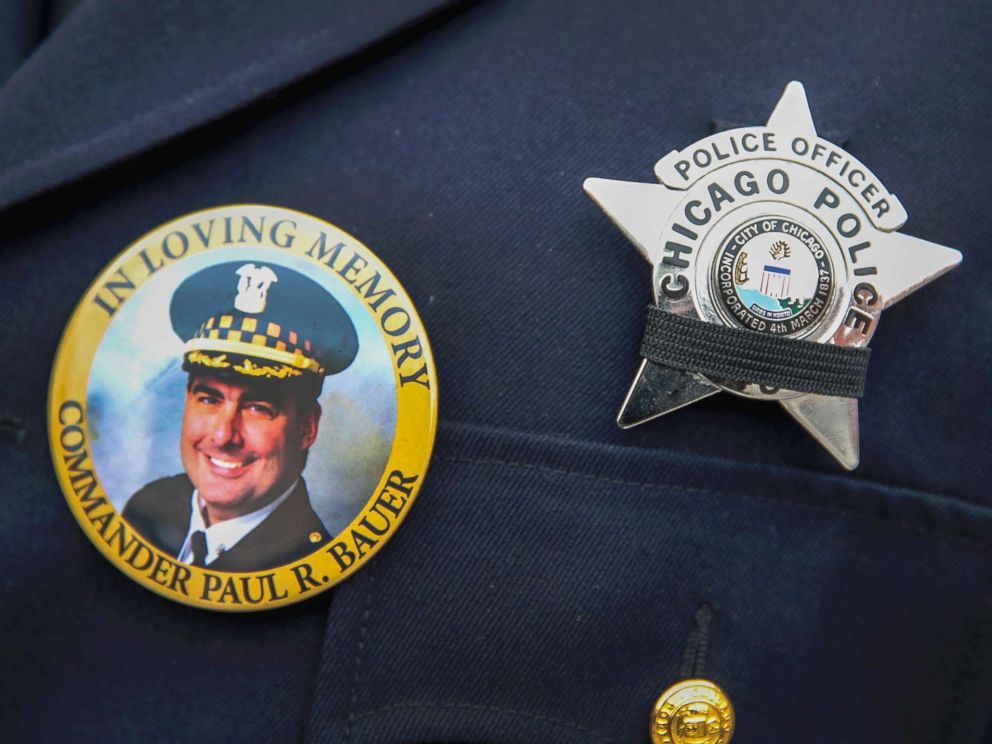 PHOTO: A photograph of Chicago police Commander Paul Bauer is seen on a pin that a Chicago police officer wears as he stands outside of the Nativity of Our Lord church in the Bridgeport neighborhood where Bauers funeral was held Feb. 17, 2018. 