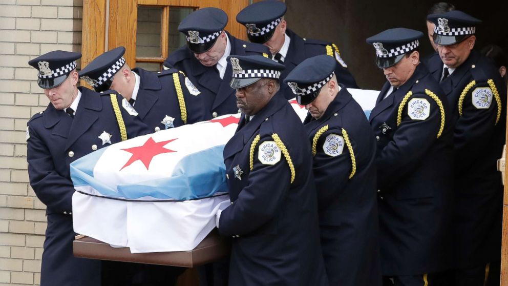 The casket containing the remains of Chicago Police Cmdr. Paul Bauer are carried to a hearse after a funeral mass for Bauer, killed in the line of duty, at The Nativity of Our Lord Catholic Church, Feb. 17, 2018, in Chicago. 