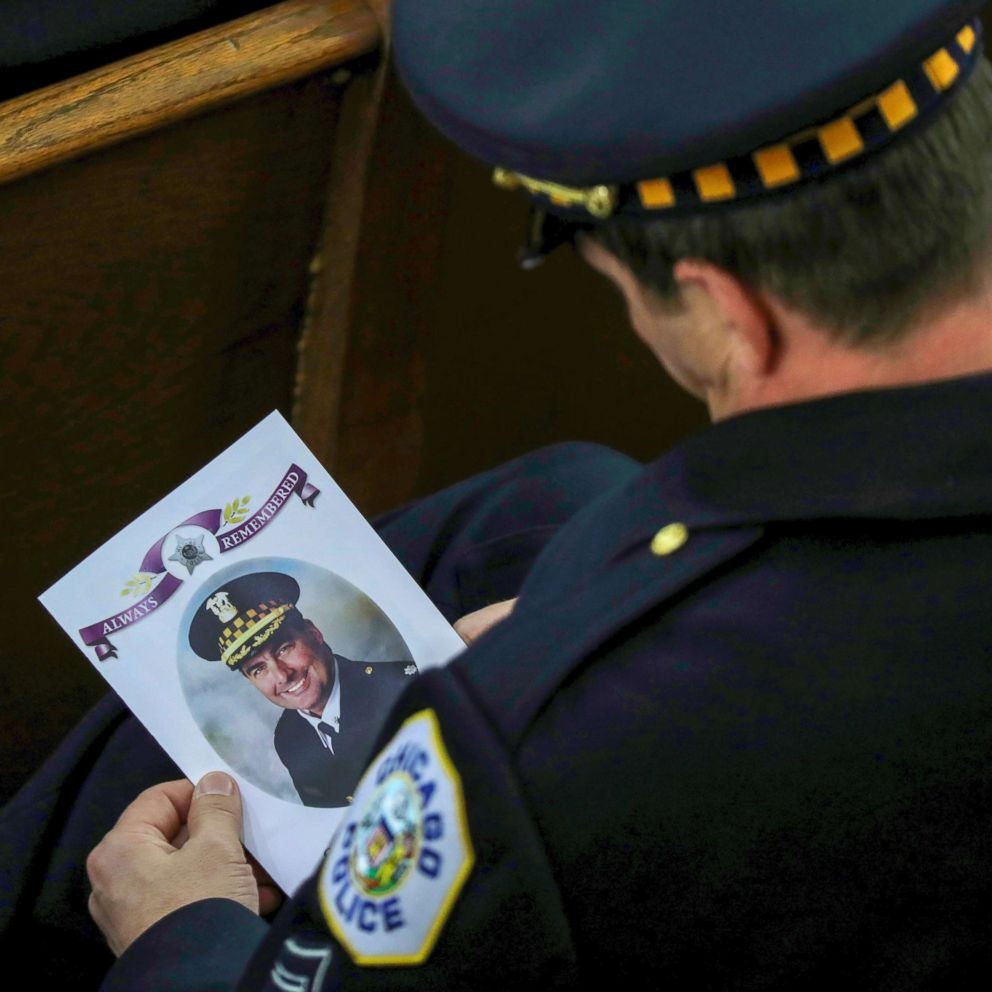 PHOTO: An 18th District officer holds the program for the funeral mass of Chicago police Commander Paul Bauer at Nativity of Our Lord Catholic Church, Feb. 17, 2017, in Chicago.