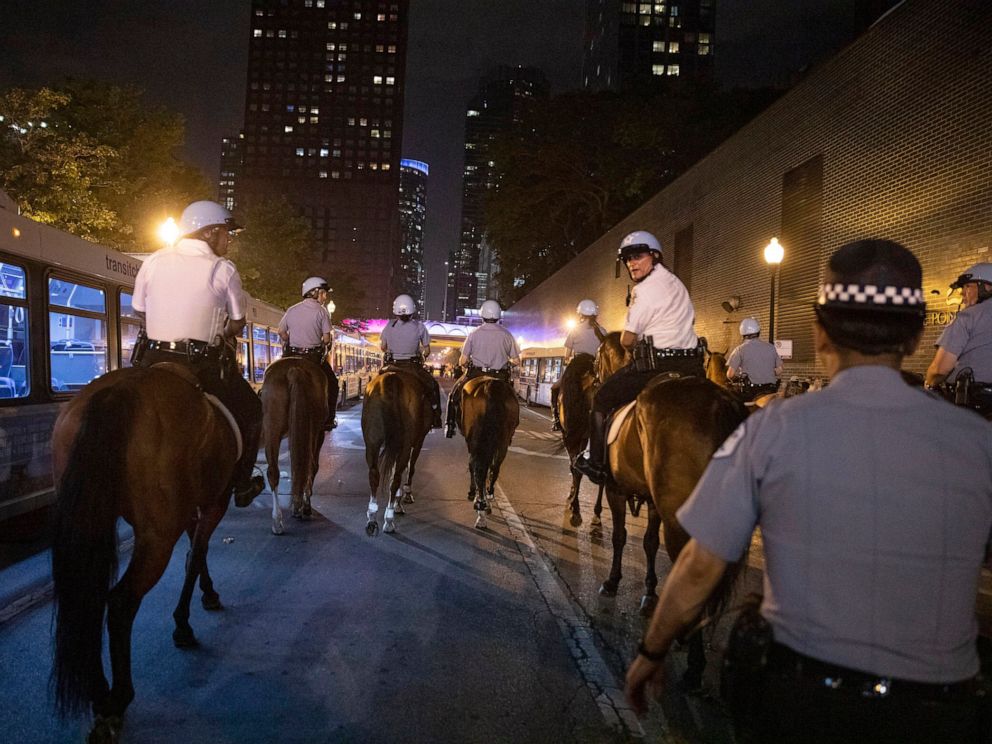 PHOTO: Chicago Police Department officers guard people as they stream out of Chicagos Navy Pier after reports of stabbings and threatening injuries after the 4th of July celebrations, July 4, 2019.