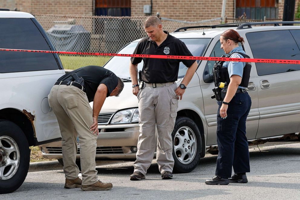 PHOTO: Law enforcement officers investigate a crime scene near the border between the Morgan Park and West Pullman neighborhoods, July 7, 2021, in Chicago.