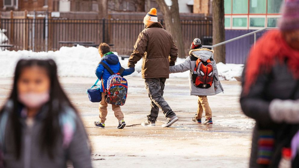 PHOTO: Students leave Darwin Elementary School in Chicago at the end of the day, Tuesday, Jan. 4, 2022.